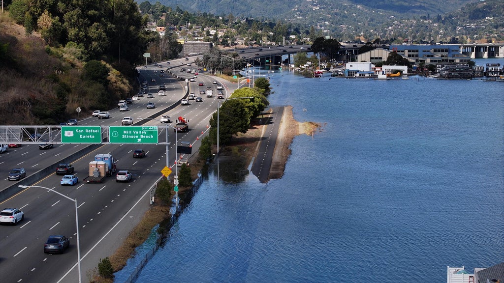 Bay Area shoreline experiencing high tide flooding with homes in the background